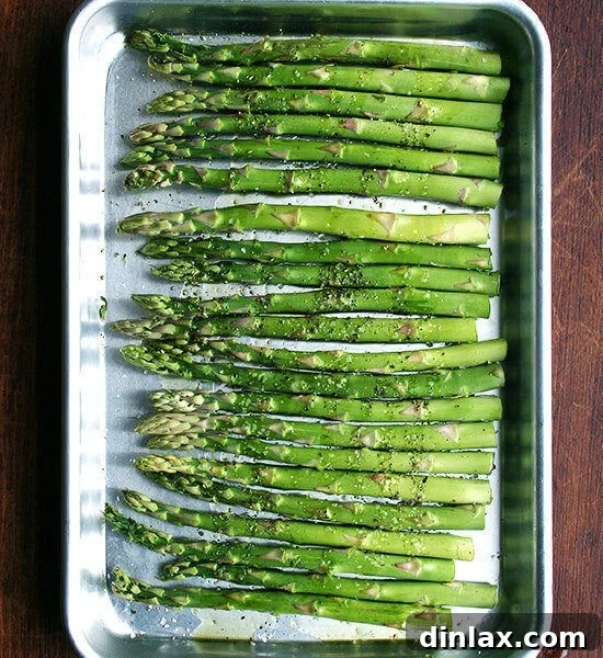 Perfectly roasted asparagus on a baking sheet.