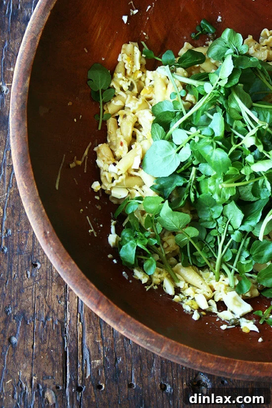 Fresh, crisp watercress, a crucial green that adds a peppery freshness and delightful crunch to the finished pasta dish.