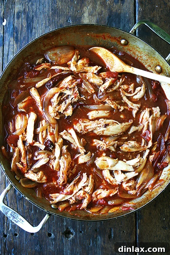 Spicy Smoky Chicken Tinga Tacos 7 A close-up of a skillet filled with fully combined and rich chicken tinga mixture.