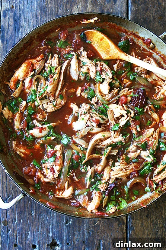 Homemade chicken tinga, rich in flavor and ready to enjoy. A skilled filled with perfectly cooked and flavorful chicken tinga, ready for serving.