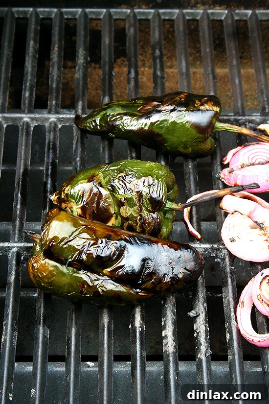 Smoky Grilled Poblano and Corn Salsa Tacos 3 Poblano peppers, corn, and red onions grilling on high heat, developing a beautiful char and smoky flavor essential for the salsa.