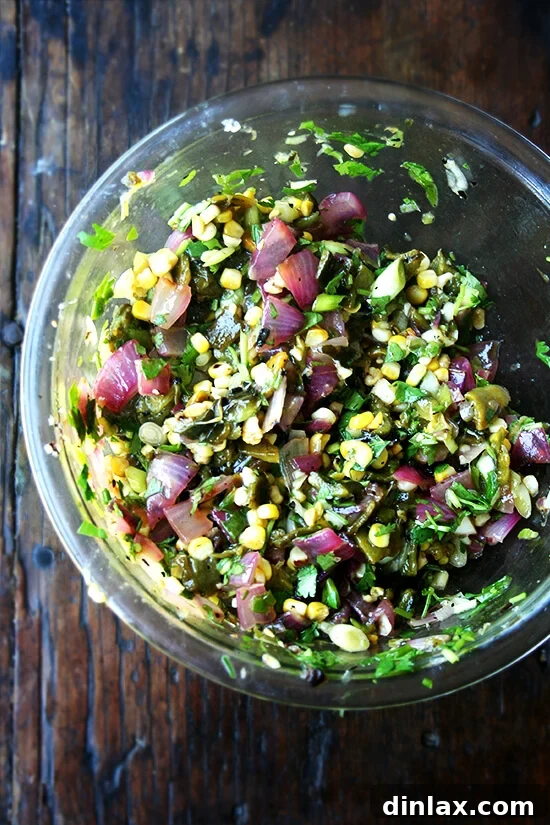 A mouthwatering steak taco, generously topped with homemade grilled poblano corn salsa, avocado, and sour cream, promising culinary delight. Close-up of a loaded steak taco with grilled poblano corn salsa, diced avocado, and a dollop of sour cream, showcasing a perfect bite, ready to be devoured.