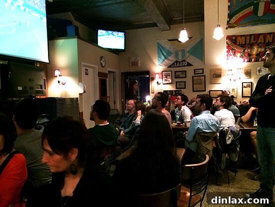 People watching a Japan vs. Ivory Coast soccer game at Café Olympico.