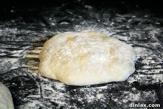 Burrata Basil Summer Squash Pizza 3 A pristine round of freshly prepared pizza dough, lightly dusted with flour, resting peacefully on a wooden board, awaiting its transformation.