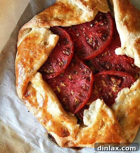 A sheet pan with two freshly baked savory galettes.