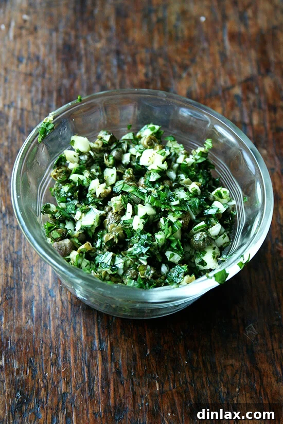 Bright Zucchini Sauté with Mint, Basil and Pine Nuts 4 A mound of finely minced garlic, mint, basil, and capers, ready to be added to the sautéed squash, referred to as 'knife pesto'.