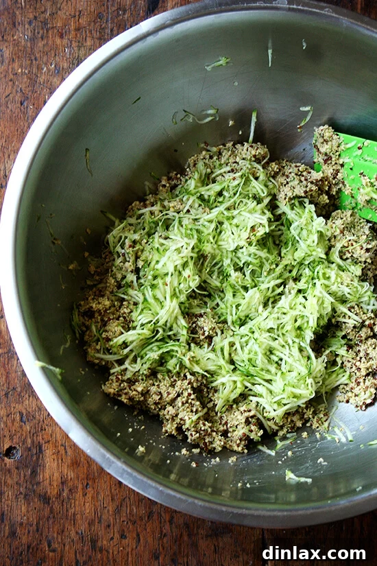 Plant-Powered Chickpea Quinoa Burgers 8 Grated zucchini being folded into the veggie burger mixture