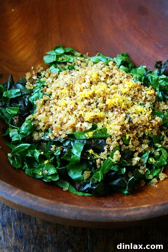Tangy Swiss Chard Salad with Parmesan and Crunchy Breadcrumbs 7 A large bowl containing finely chopped Swiss chard, lemon zest, and toasted breadcrumbs, ready for the next step.
