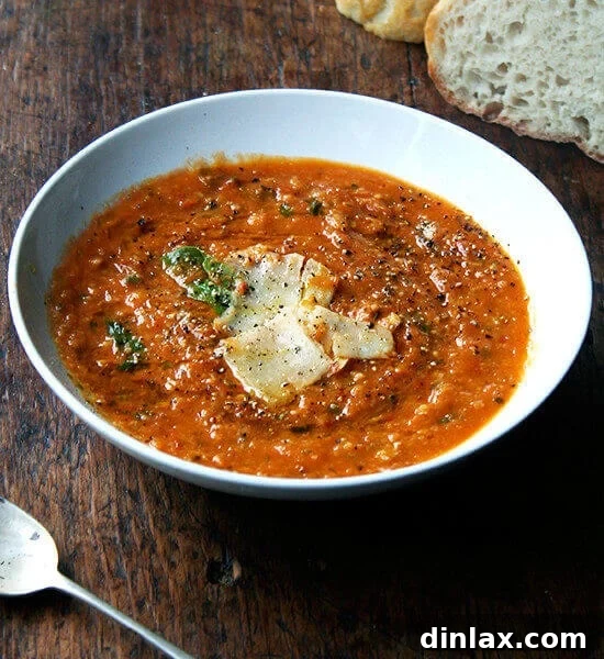 A bowl of luscious roasted tomato and bread soup (Pappa al Pomodoro) garnished with fresh basil, ready to be enjoyed.