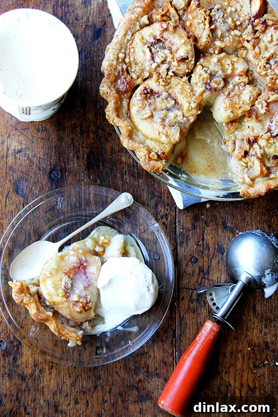 Golden-baked German peach pie, featuring tender, halved peaches nestled in a rich vanilla custard, topped with a delicate nut crumble. Perfect with a scoop of vanilla ice cream, embodying the warmth of homemade summer desserts.