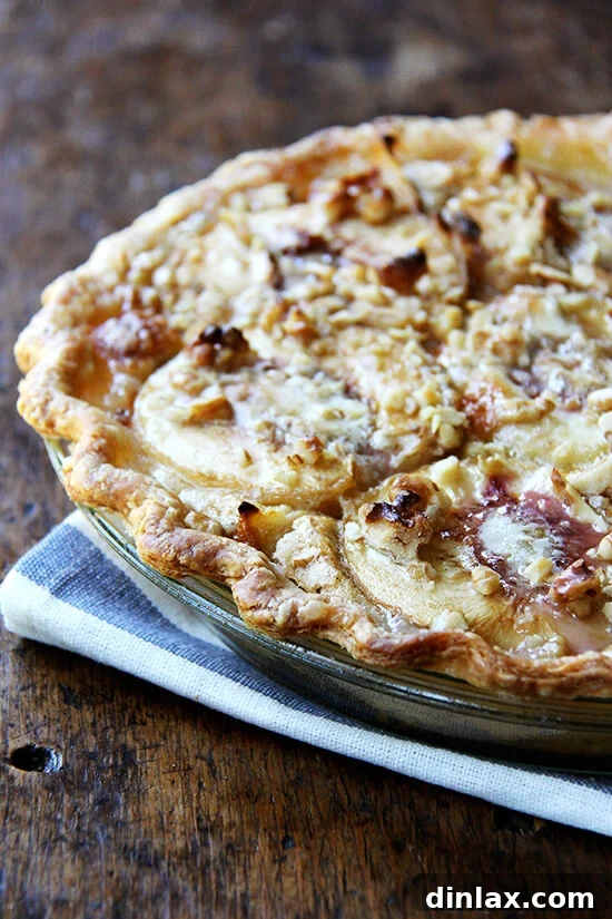 Freshly baked German peach pie, a warm and inviting summer dessert, boasting a rich, golden-brown custard and tender peaches.