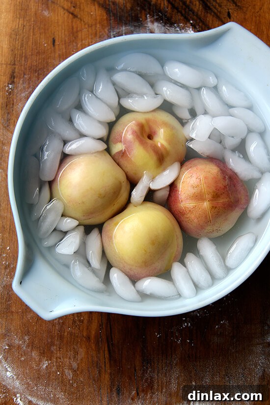 Blanched and peeled peaches, smooth and ready to be halved for the German Peach Pie recipe.