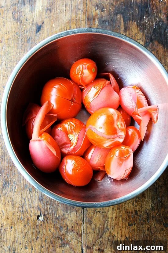 Blanched tomatoes in a bowl, skins removed and ready for sauce making