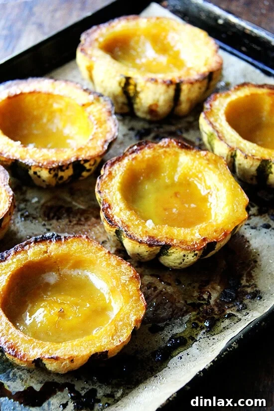 Caramelized Maple Acorn Squash 10 A sheet pan with 6 golden roasted acorn squash halves, beautifully caramelized with maple butter, ready to serve.