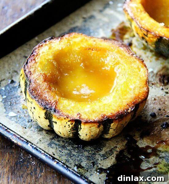 Roasted acorn squash with maple butter on a sheet pan.