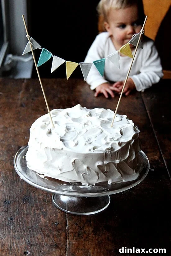 The infamous 'disgusting' birthday cake, topped with beautiful white meringue icing and a festive bunting.