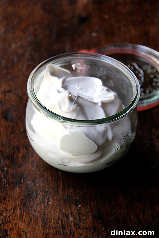 A bowl of fluffy, white homemade meringue, perfectly whipped and ready to be used or torched.