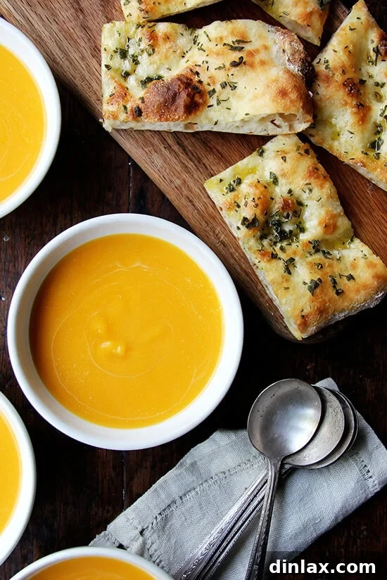 Bowls of rich butternut squash and cider soup, perfectly complemented by herbed flatbreads.