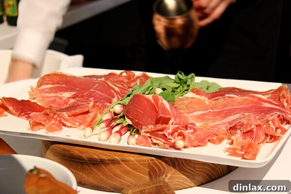 Gourmet prosciutto beautifully arranged, a highlight of the summit's culinary offerings.