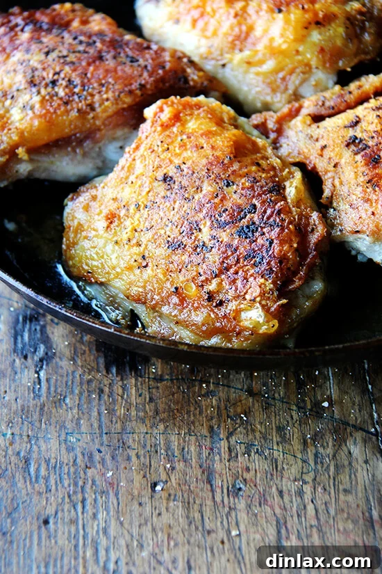 A skillet filled with perfectly crispy chicken thighs and preserved lemon, ready to be served.