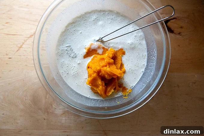 Golden Roasted Butternut Bliss Pie 11 A large mixing bowl now containing the whisked cream, eggs, sugar, spices, and 2 cups of the creamy butternut squash purée.