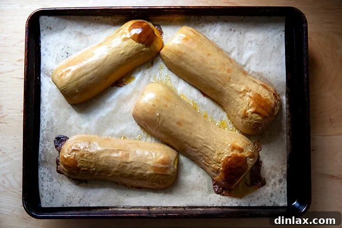 Golden Roasted Butternut Bliss Pie 6 Two halves of perfectly roasted butternut squash, cooked until tender, resting on a sheet pan.