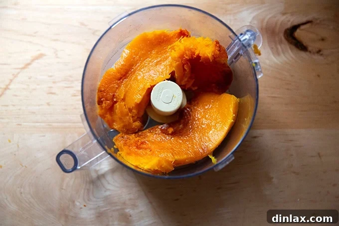 Golden Roasted Butternut Bliss Pie 7 A food processor bowl filled with warm, scooped-out roasted butternut squash, ready for puréeing.