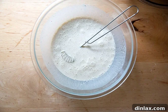 Golden Roasted Butternut Bliss Pie 10 The mixture of cream, eggs, sugar, and spices thoroughly whisked together in a large bowl, creating a smooth base for the pie filling.