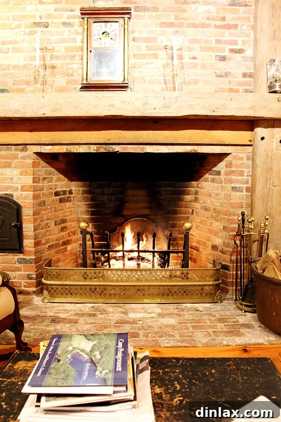 A warm, crackling fire blazes in a rustic brick fireplace, creating a cozy ambiance.