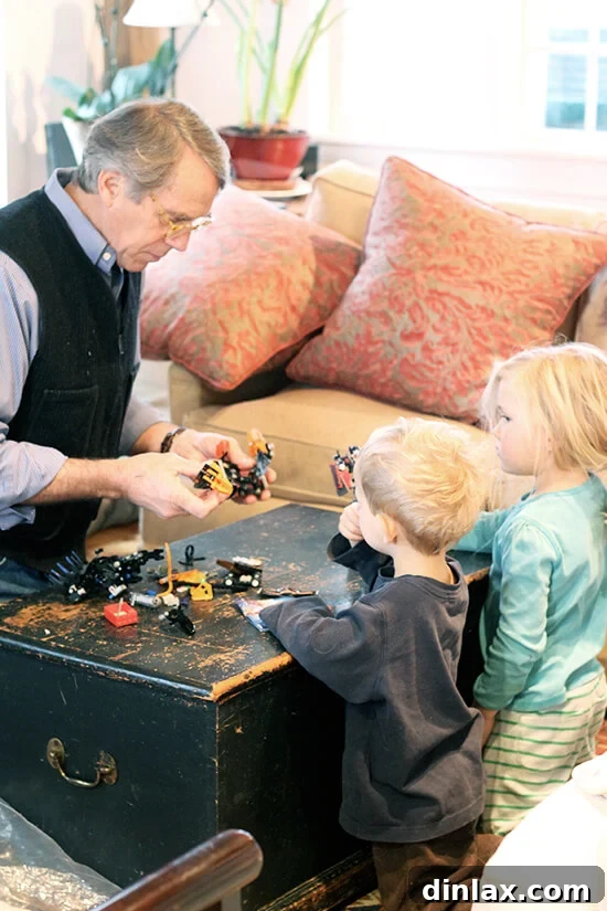Uncle Wade engages in playful interaction with children Graham and Ella, building with Legos.