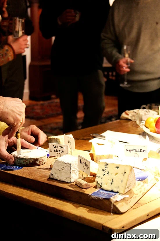 An appetizing display of Jasper Hill Farm cheeses presented on a wooden board.
