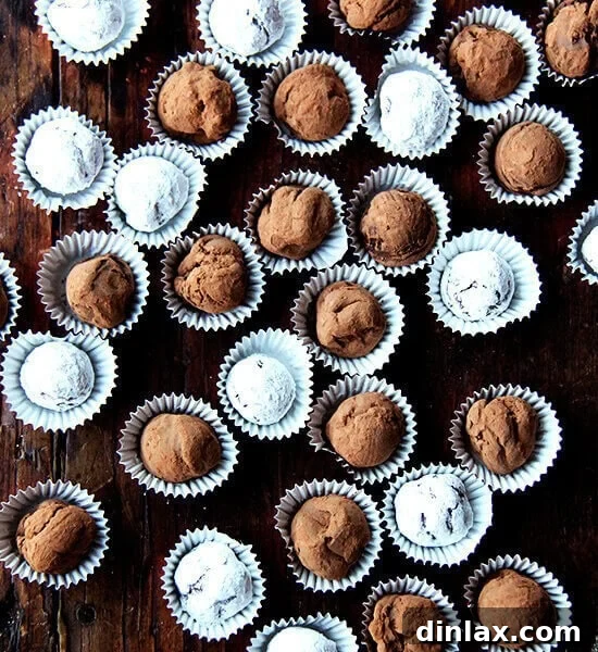Decadent Grand Marnier Chocolate Truffles 14 An overhead shot of a table lined with boozy chocolate truffles.