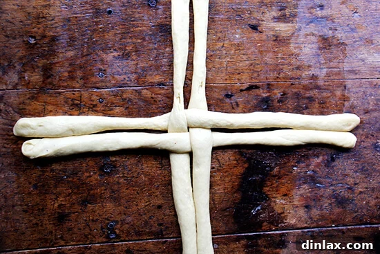 Step 2: Gently intertwining Challah bread dough ropes to form a round loaf.