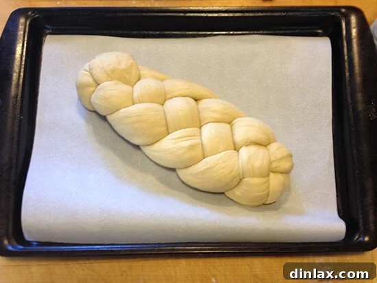 Holly's perfectly braided Challah bread on a sheet pan, ready for the oven.