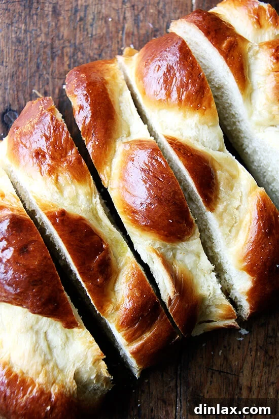 Slices of day-old Challah bread, expertly cut and ready for preparing French toast.