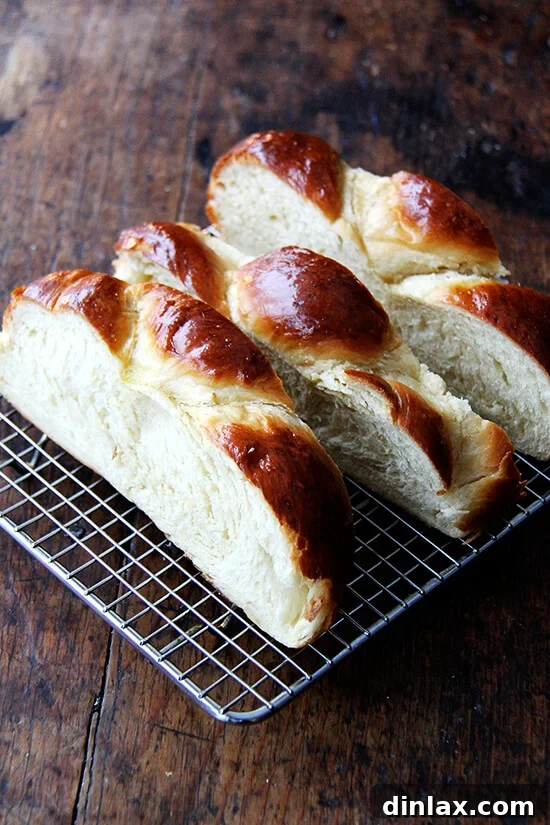 A cooling rack holding sliced day-old Challah bread, allowing it to dry out for perfect French toast.