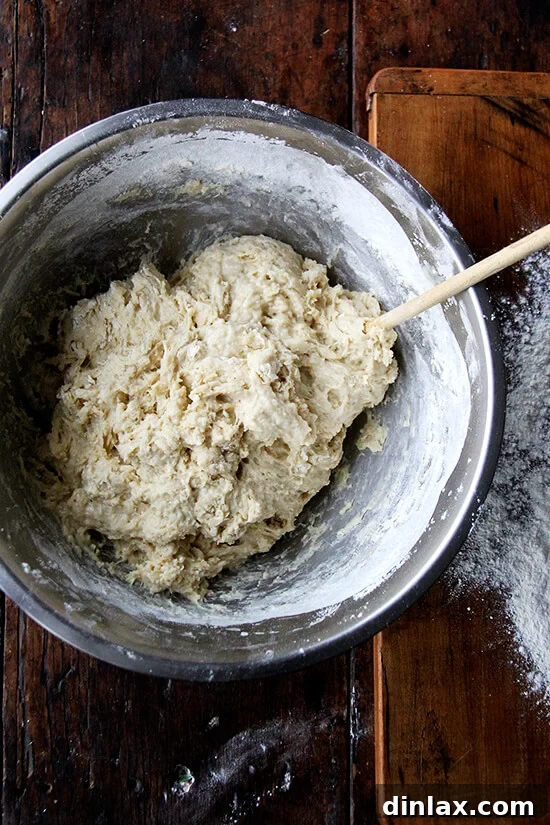 The Challah bread dough mixing into a sticky yet cohesive mass.