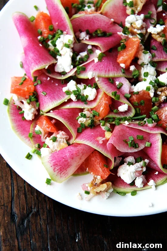 This beautiful salad is a mix of paper-thin watermelon radishes, Cara Cara oranges — so sweet and pretty — toasted walnuts and goat cheese, dressed with shallots macerated in vinegar, olive oil, and chives. If you don't have radishes on hand, turnips work, too, and so do beets (cooked first, though raw might be interesting? and messy?). // alexandracooks.com Fully dressed Watermelon Radish, Goat Cheese, Chives, and Walnut Salad, ready to be served.