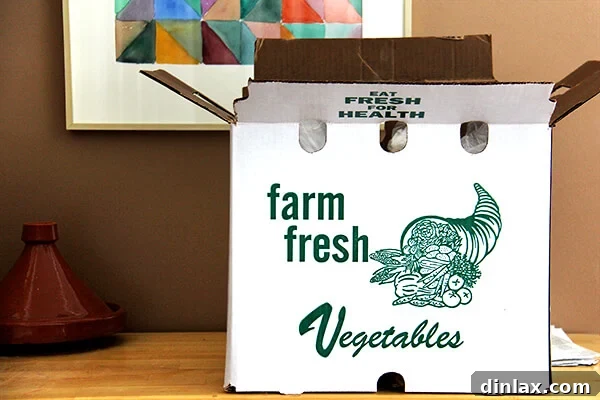 Vibrant Watermelon Radish, Orange, and Goat Cheese Salad 8 A CSA delivery box filled with farm-fresh produce, highlighting the commitment to local and seasonal eating.