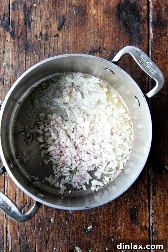Martha Stewart's Legendary Hot Crab Dip 3 Minced shallots gently simmering in melted butter, a crucial first step for building complex flavor in the hot crab dip.