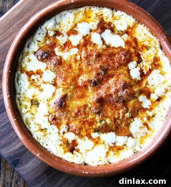 A beautifully baked Classic Hot Crab Dip, garnished with fresh herbs and ready to be enjoyed.