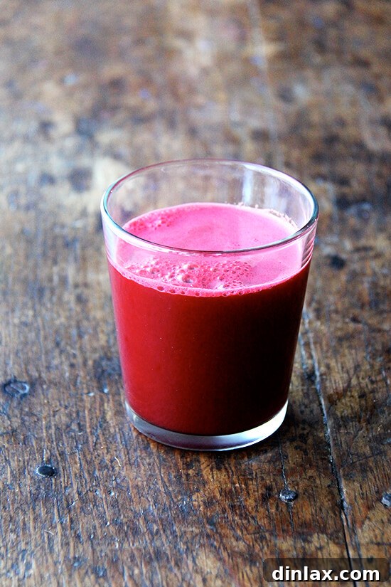 From Juicer Broths to Liege Waffles and Swedish Snack Bread 2 A refreshing glass of homemade beet, carrot, apple, and clementine juice, showcasing its vibrant color and healthy appeal.
