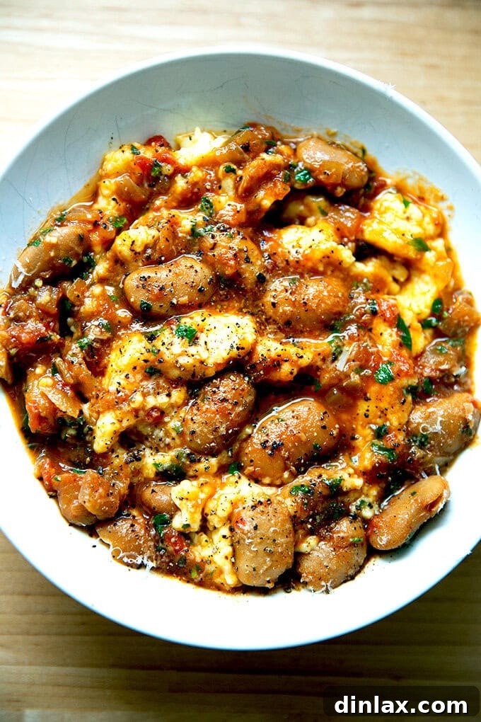 A bowl of creamy slow cooker gigante beans, garnished with fresh herbs and a drizzle of olive oil, ready to be enjoyed.