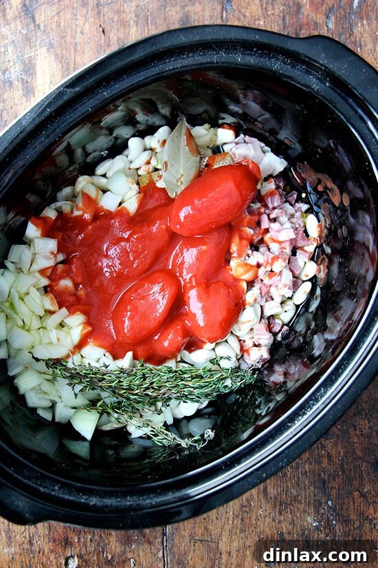 A crockpot showcasing high-quality San Marzano tomatoes, ready to be incorporated into the bean mixture for rich flavor.