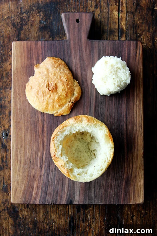 A perfectly baked individual bread bowl, ready to be hollowed out.