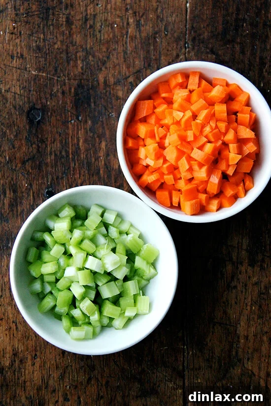 Finely diced carrots and celery added to the slow cooker with the cooked beans.