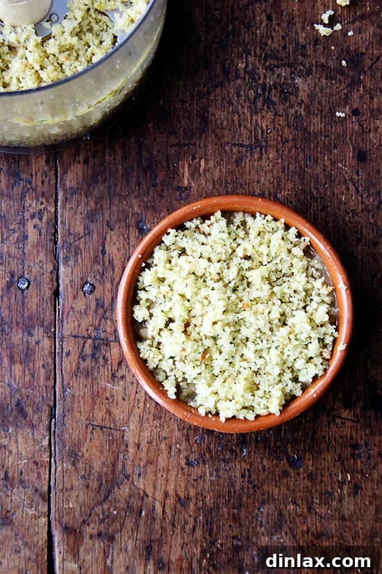 Close-up of gratin dishes with beans completely covered by a thick layer of herbed breadcrumbs, ready for baking.
