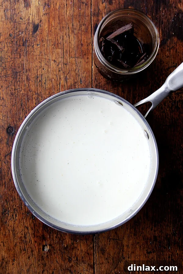 Velvet Vanilla Bean Custard 2 Close-up of fresh heavy cream infused with fragrant vanilla beans, ready to be heated for the custard base.