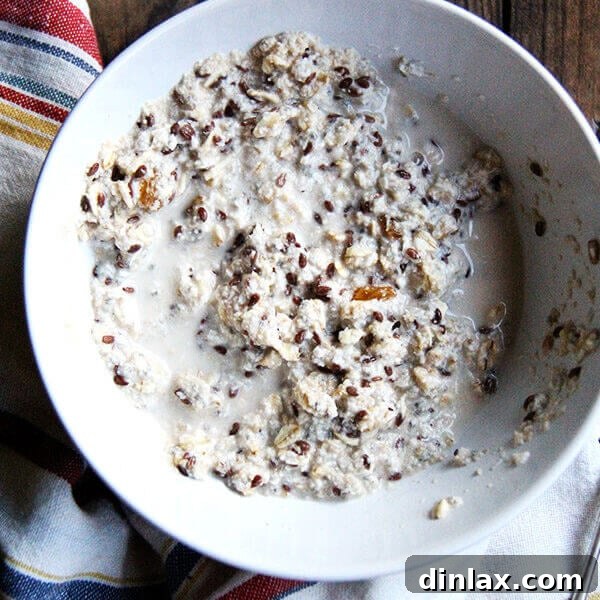 A close-up shot of a bowl of homemade muesli, featuring visible oats, nuts, and dried fruits, emphasizing its natural and wholesome ingredients.