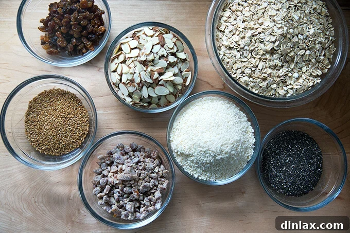 A collection of fresh, dry ingredients laid out on a clean surface, including oats, nuts, and seeds, prepared for mixing into homemade muesli.